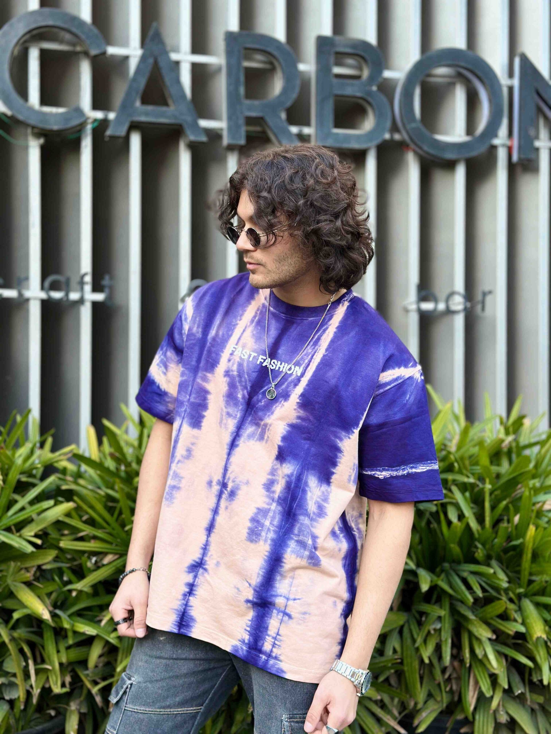 Men in fast fashion Mix Purple-Cream Acid Wash Oversized T-Shirt with goggles in style in front of garden