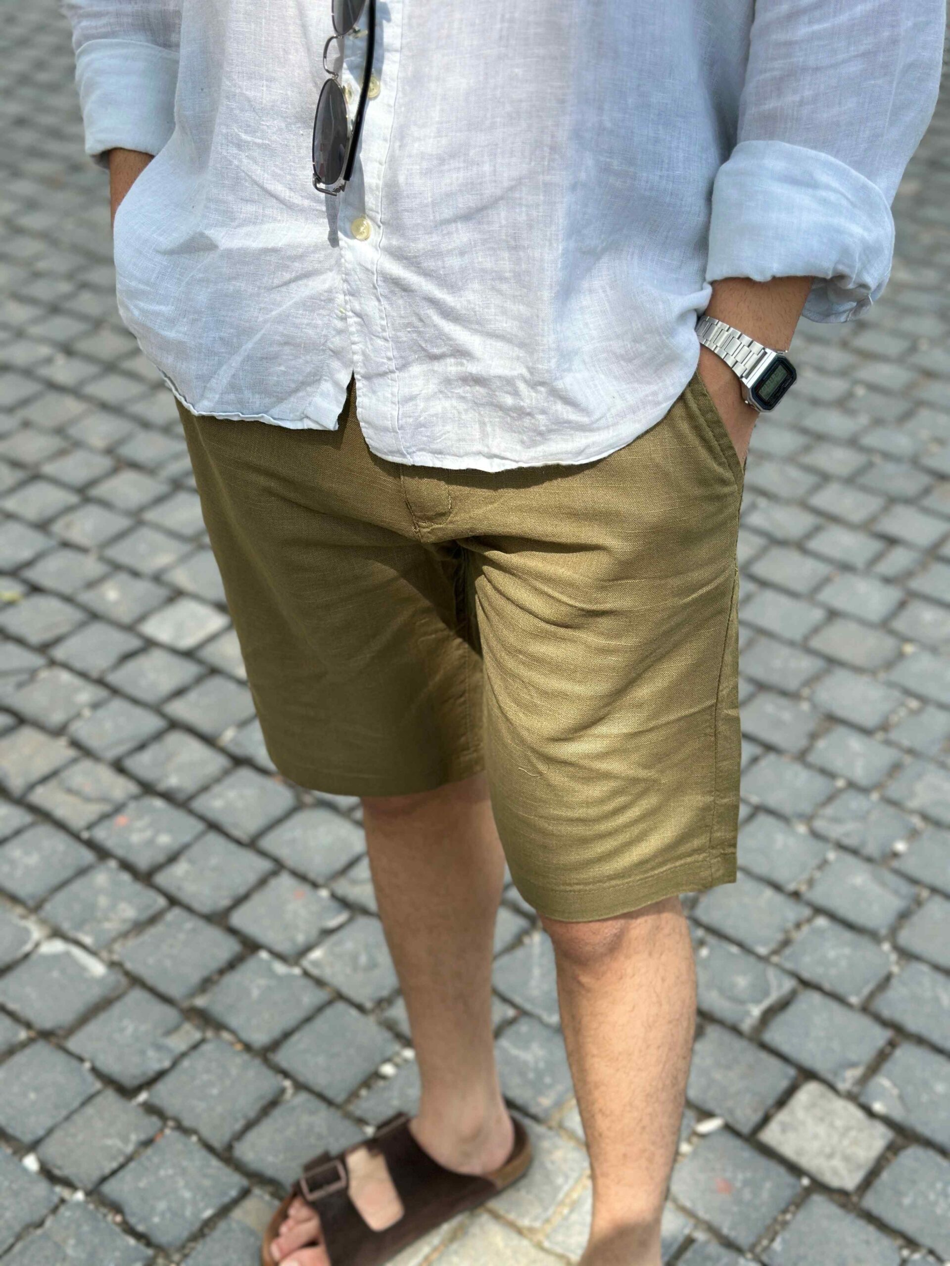 Close-up of men's khaki linen shorts, highlighting the breathable fabric and quality texture, perfect for warm weather.