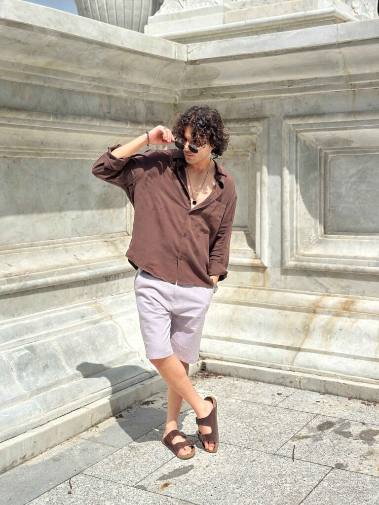 Stylish look with sunglasses, brown shirt, and Magento linen shorts for summer wear